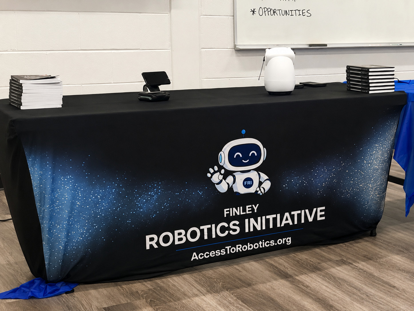 Finley Robotics Initiative table with robots and books at the Ready.Set.Lead event